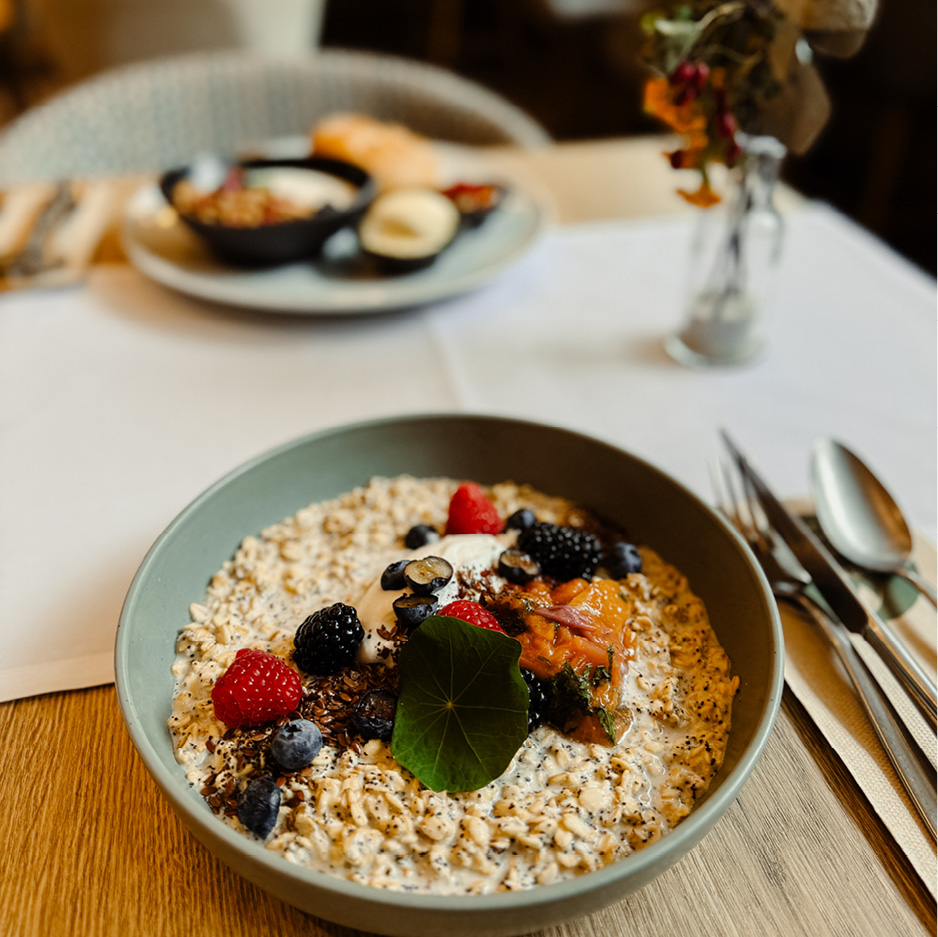 Das Bild zeigt eine Granola-Joghurt-Bowl auf einem Frühstückstisch bei kulinario.